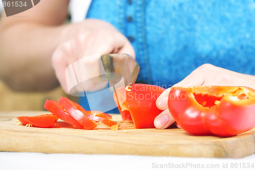 Image of Woman hands cutting paprika