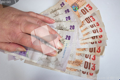 Image of hand on £200 cash