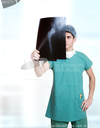 Image of doctor holding up xrays.