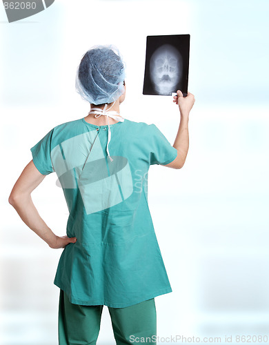 Image of doctor holding up xrays.
