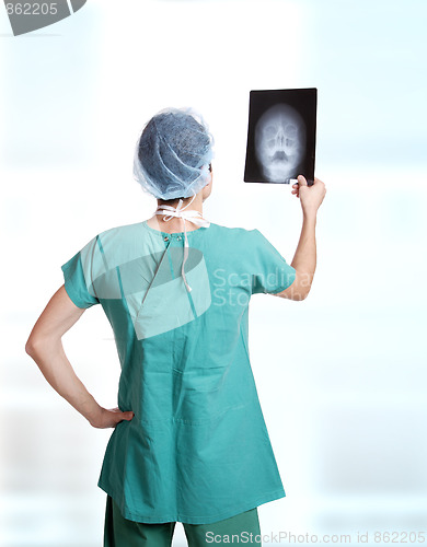 Image of doctor holding up xrays.