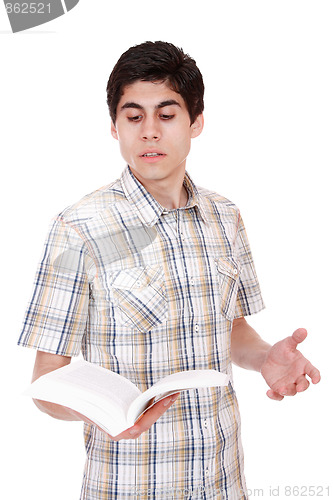 Image of Handsome young man reading a book