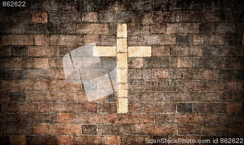Image of christian cross in brick wall