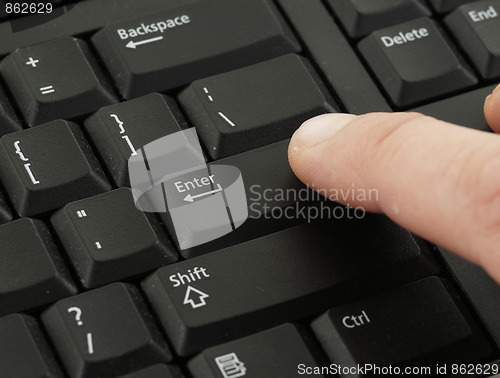 Image of finger pressing keyboard