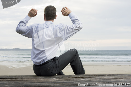 Image of Businessman relaxing at the sea