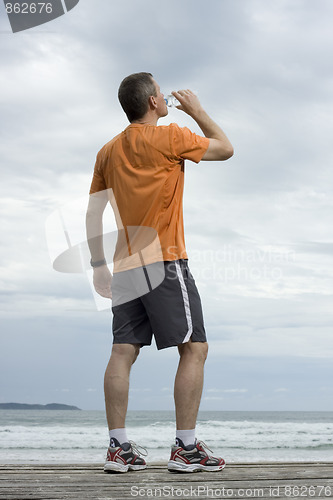 Image of Mature athlete drinking water