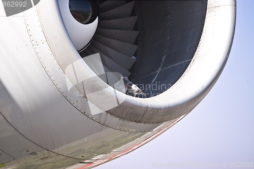 Image of Detail view of a jet plane engine, with two doves