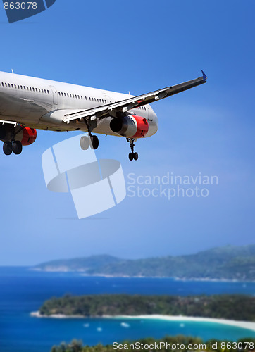 Image of Airplane landing on tropical country