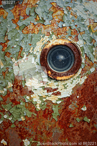 Image of peeling door with a spy-hole