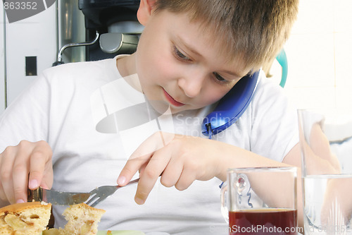 Image of Boy at breakfast with phone