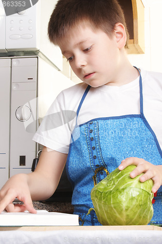 Image of Boy with cabbage and cookbook