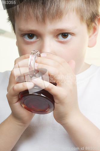 Image of Boy in white drinks tea