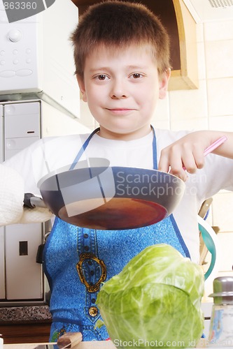 Image of Smiling boy with frying-pan