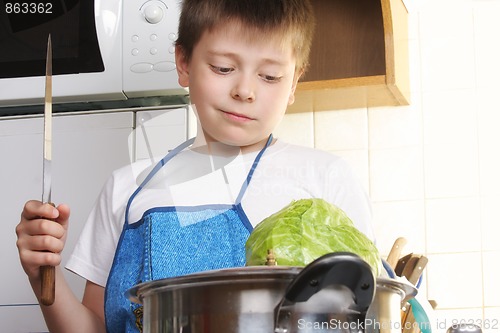 Image of Boy with cabbage and knife