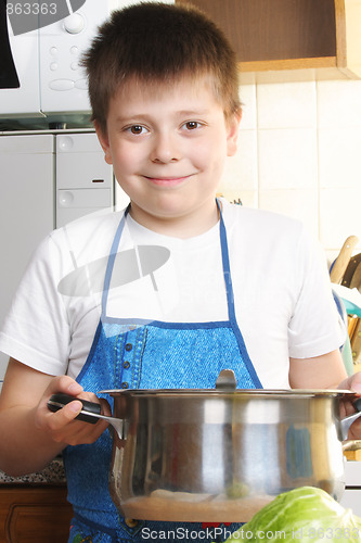 Image of Smiling boy with saucepan