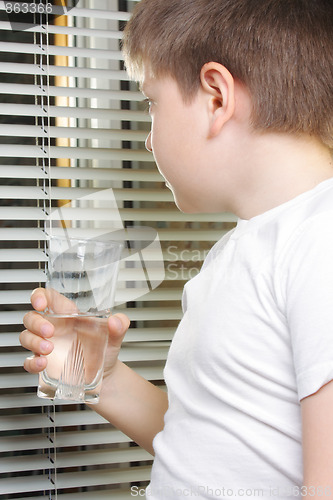 Image of Boy in white looking to window
