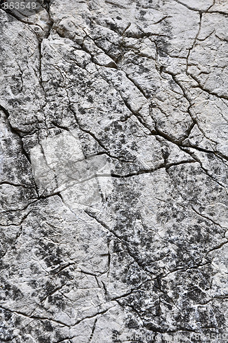 Image of close up texture of grey stone with cracks