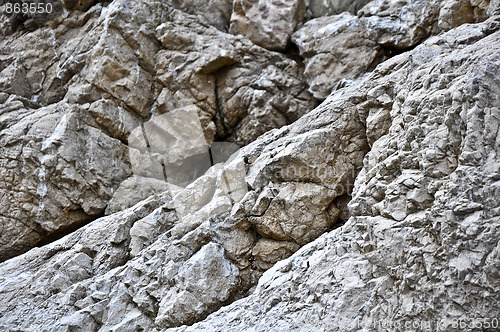 Image of close up texture of grey stone with cracks