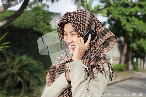 Image of Muslim girl calling by cellphone