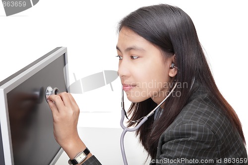 Image of Businesswoman examining PC screen w stethoscope