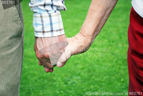 Image of senior couple holding hands