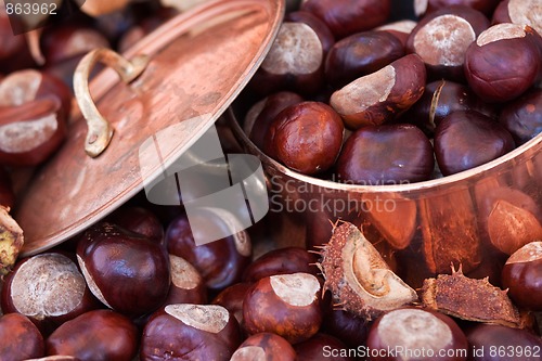 Image of Chestnuts and copper kettle, autumn concept image