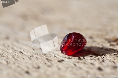 Image of Pomegranate aril on wooden board