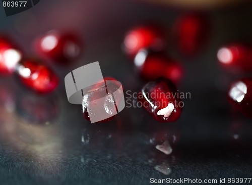 Image of Pomegranate aril on black glass