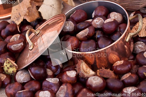 Image of Chestnuts and copper kettle, autumn concept image