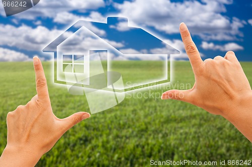 Image of Female Hands Framing House Over Grass and Sky