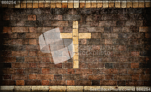 Image of christian cross in brick wall