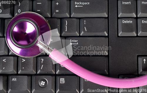 Image of pink stethoscope on keyboard