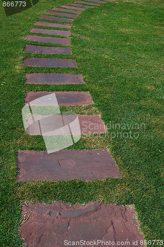 Image of Tilled footpath on the green lawn.