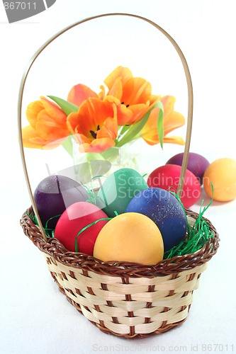 Image of Easter basket with Easter eggs and tulips