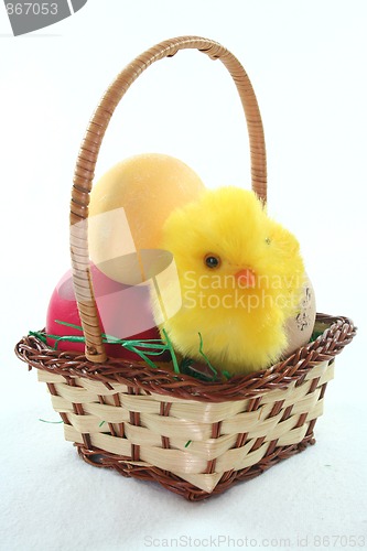 Image of Easter basket with Easter eggs and chicks