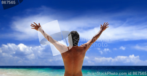 Image of Man standing looking at ocean