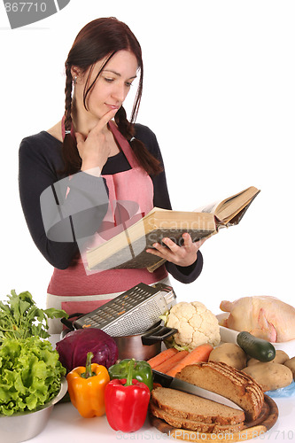 Image of housewife thinking with a book recipe