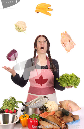 Image of housewife juggling with fruit and vegetables