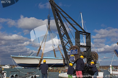 Image of Family lowering boat into water