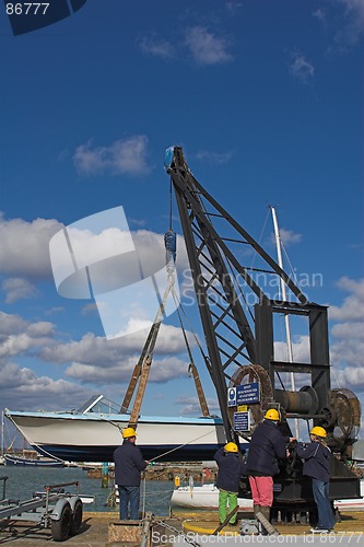 Image of People putting boat into water