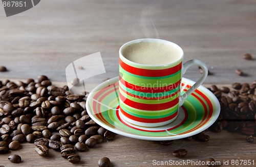 Image of Coffee in striped cup with beans