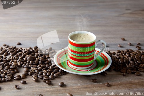 Image of Coffee in striped cup with beans