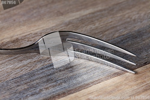 Image of Steel Fork on wooden Table