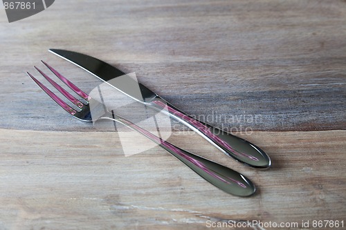 Image of Steel Fork and knife on wooden Table