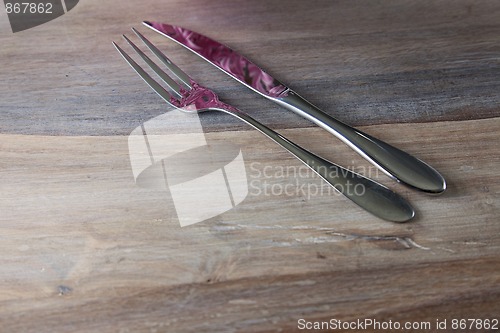 Image of Steel Fork and knife on wooden Table