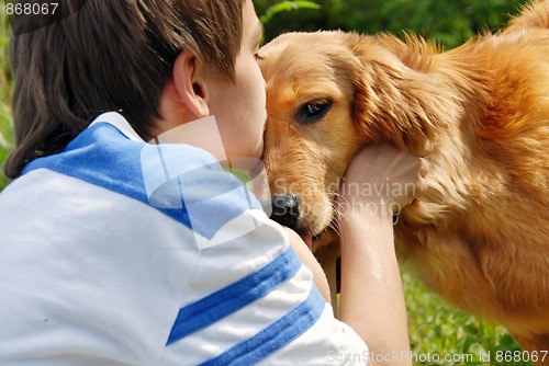 Image of Boy kissing dog