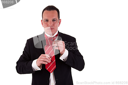 Image of Businessman putting on tie