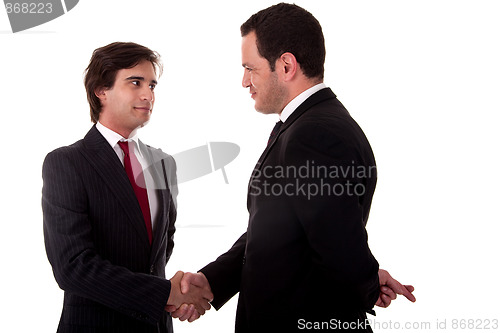 Image of two businessmen shaking hands, and one businessman with his fingers crossed behind his back and smiling