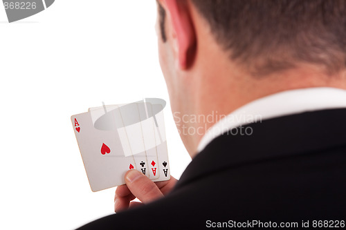 Image of detail of the shore of a man with four cards with four aces in hand