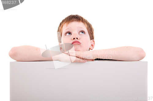 Image of cute  boy looking up with white board